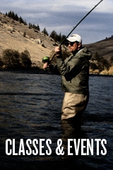 A man up to his knees casting in the middle of a river